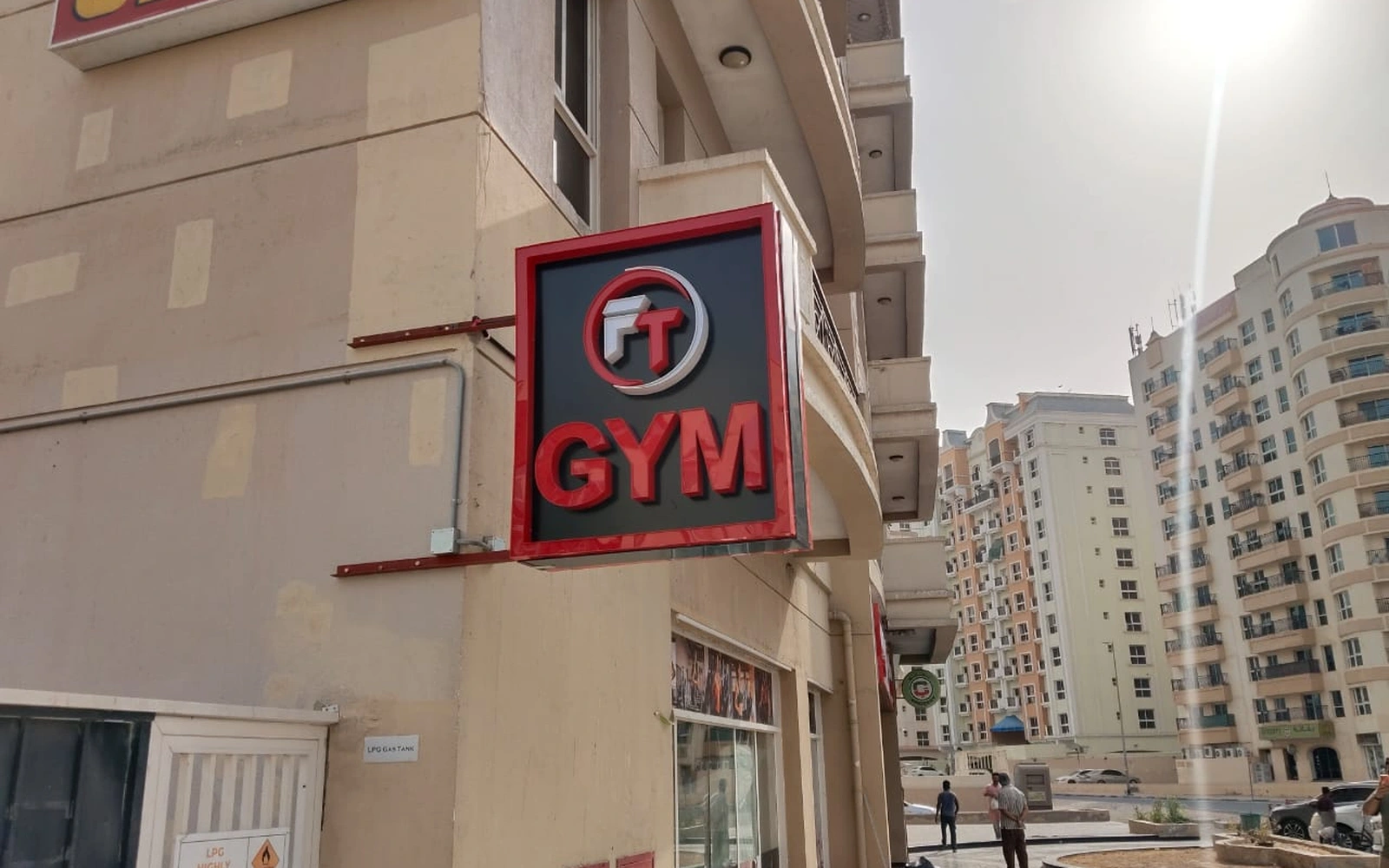 Red and black FT GYM projecting sign on a building exterior